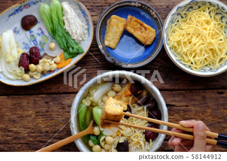 People eating Vietnamese vegan noodle soup for breakfast People eating Vietnamese vegan noodle soup for breakfast 58144912
