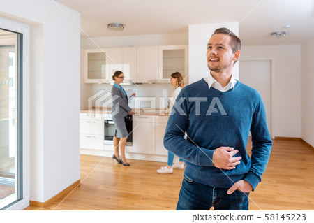 Man being satisfied with the new apartment he wants to buy Man being satisfied with the new apartment he wants to buy 58145223