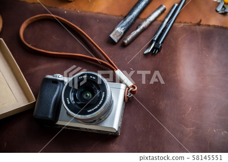 Mirrorless vintage camera with leather strap and Mirrorless vintage camera with leather strap and 58145551