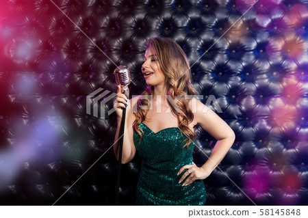 Beauty Woman with retro Microphone over dark Beauty Woman with retro Microphone over dark 58145848
