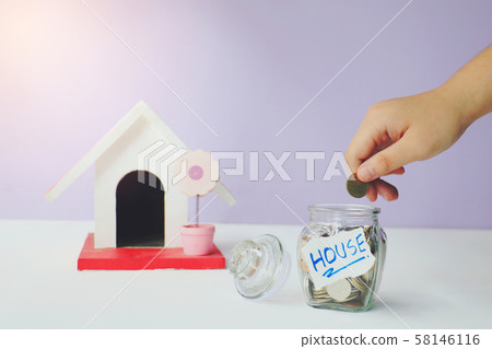 Saving  money. A hand putting money in bottle.The coins in the bottle for save money.Photo financial saving and  Saving  money. 58146116