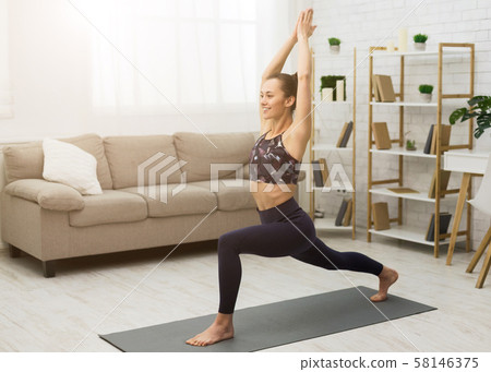 Fitness concept. Happy woman practicing yoga at home Fitness concept. Happy woman practicing yoga at home 58146375