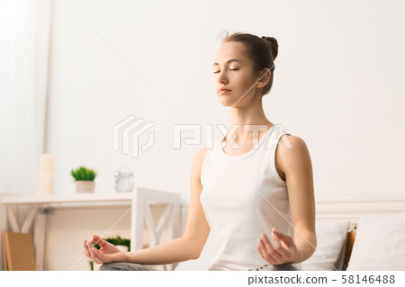 Calm morning. Woman doing yoga in lotus position 58146488