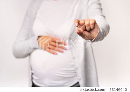Pregnant Girl Showing Pill Touching Belly Over White Background, Cropped Pregnant Girl Showing Pill Touching Belly Over White Background, Cropped 58146640