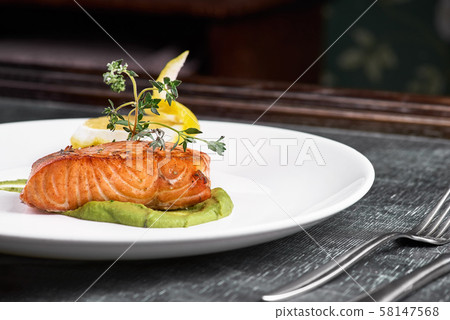 Grilled salmon with vegetables served on a plate Grilled salmon with vegetables served on a plate 58147568