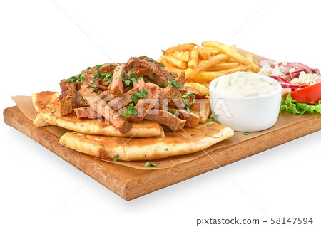 traditional Greek dish called Gyros pita and fries traditional Greek dish called Gyros pita and fries 58147594
