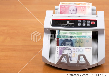 Estonian kroon in a counting machine Estonian kroon in a counting machine 58147957