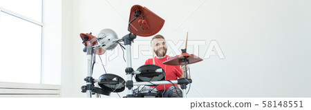 Drummer, drum, music and people concept - young man drummer playing in the white room Drummer, drum, music and people concept - young man drummer playing in the white room 58148551
