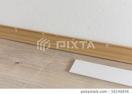 Installing plastic skirting board in the room 58148856