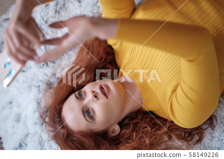 Smiling attractive young woman with beautiful long Smiling attractive young woman with beautiful long 58149226