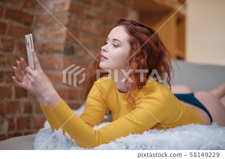 Smiling attractive young woman with beautiful long Smiling attractive young woman with beautiful long 58149229