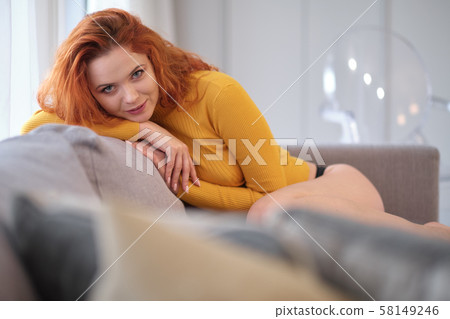 Portrait of a red-haired girl in a yellow sweater Portrait of a red-haired girl in a yellow sweater 58149246