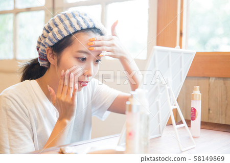 A young woman doing skin care 58149869