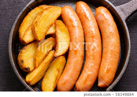 Wiener sausage and french fries (with skin) assorted in skillet. Wiener sausage and french fries (with skin) assorted in skillet. 58149884