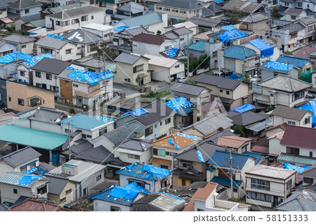 Tile roof damaged by strong wind 58151333