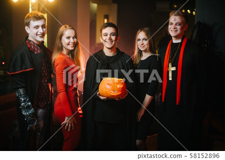 Young people in costumes are celebrating Halloween 58152896
