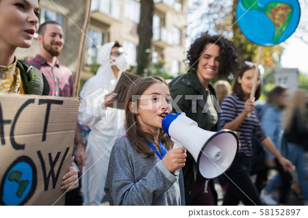 Small child with amplifier on global strike for climate change. Small child with amplifier on global strike for climate change. 58152897