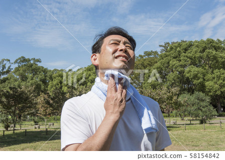 Mature man wiping sweat after exercising in Yoyogi Park 58154842
