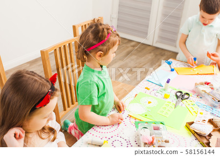 Little children make lovely postcards at a workshop 58156144