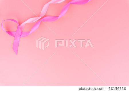 Pink ribbon breast cancer on pink background with copy space for text. Flat lay, top view. Pink ribbon breast cancer on pink background with copy space for text. Flat lay, top view. 58156538