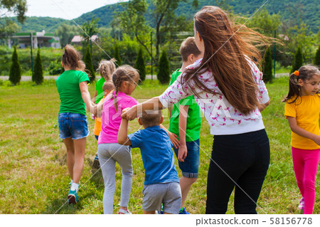 utor with kids play in outdoor games and have fun 58156778