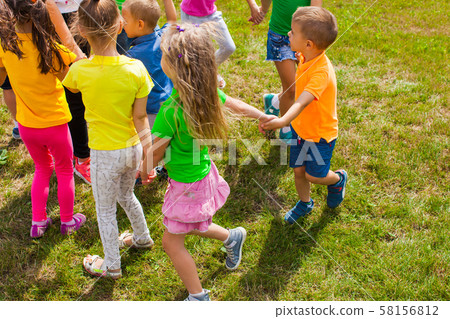 Activities for kids of different ages on green lawn 58156812