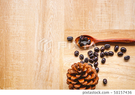 Coffee beans on a wooden spoon 58157436