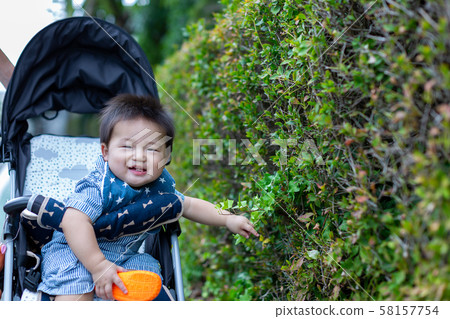 Infant and child in a stroller 58157754