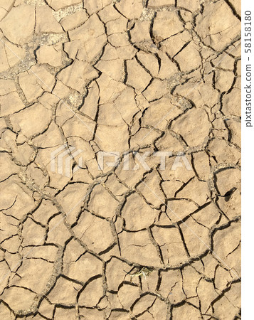 Top view closeup weathered texture and background of arid cracked ground. Broken dried mud from arid problem. Global warming crisis. Agricultural land without water. Climate change. 58158180
