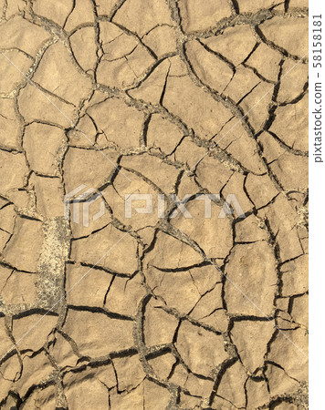 Top view closeup weathered texture and background of arid cracked ground. Broken dried mud from arid problem. Global warming crisis. Agricultural land without water. Climate change. 58158181