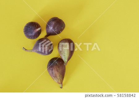Fresh figs isolated on yellow background 58158842