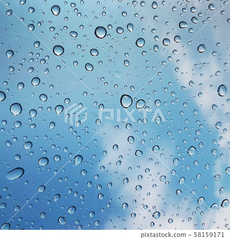 Water drops on glass with blue sky and clouds Water drops on glass with blue sky and clouds 58159171