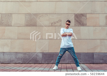 Male athlete, guy dancer in summer city. Free space for motivation text. Fashionable modern break 58159644