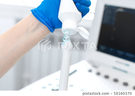 gynecologist doctor prepares an ultrasound machine gynecologist doctor prepares an ultrasound machine 58160370