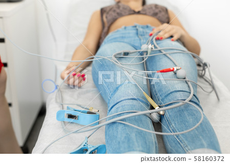 the patient lies on a couch in a medical office the patient lies on a couch in a medical office 58160372