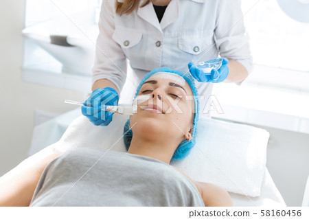 Woman professional doctor beautician applies a 58160456