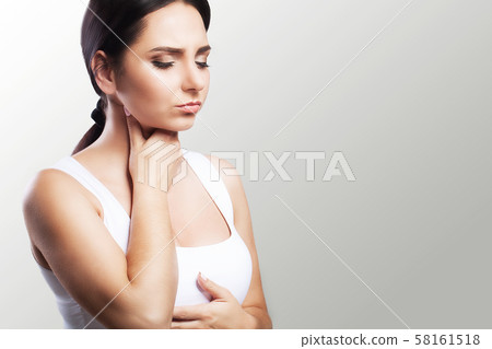 Sore throat. Sick woman, flu Young beautiful woman with sore throat. Feeling painful in the throat 58161518