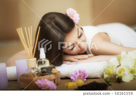 Woman at the spa. Healthy lifestyle and relaxation concept. A beautiful young woman on a massage Woman at the spa. Healthy lifestyle and relaxation concept. A beautiful young woman on a massage 58161559