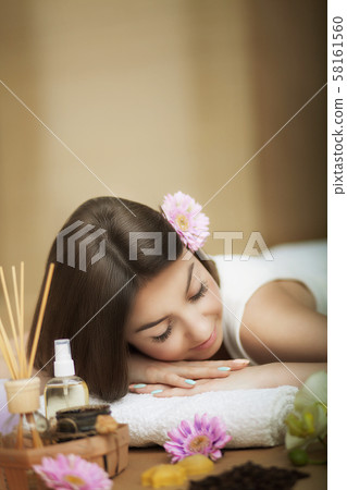 Spa. Portrait of a beautiful woman. Skin Care. Spa treatments. Flower in hair. The concept of beauty Spa. Portrait of a beautiful woman. Skin Care. Spa treatments. Flower in hair. The concept of beauty 58161560
