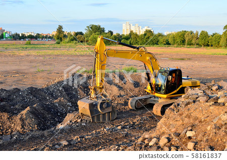 Excavator with crusher bucket for crushing concrete. Excavator with crusher bucket for crushing concrete. 58161837