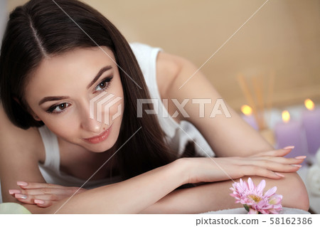 Beautiful young woman relaxing in jacuzzi hot tub at spa. Attractive female tourist is surrounded Beautiful young woman relaxing in jacuzzi hot tub at spa. Attractive female tourist is surrounded 58162386