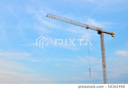 Jib construction tower cranes at a construction site on the blue sky background  58162448