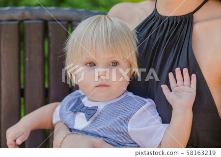 Beautiful young mother with a little son on a 58163219