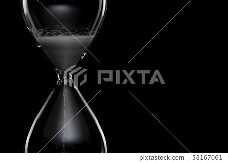 Hourglass black background 58167061