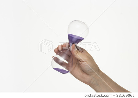 Hand holding an hourglass 58169065