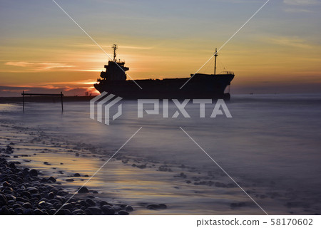Moored stranded ship on the sea with sunset dusk Moored stranded ship on the sea with sunset dusk 58170602