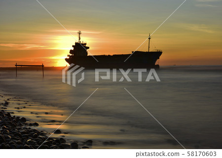 Moored stranded ship on the sea with sunset dusk Moored stranded ship on the sea with sunset dusk 58170603