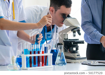 Group of scientists working in chemical lab. 58177520