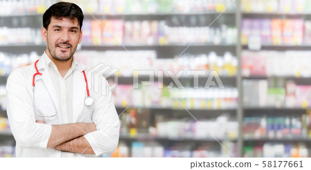 Male pharmacist working at the pharmacy. 58177661