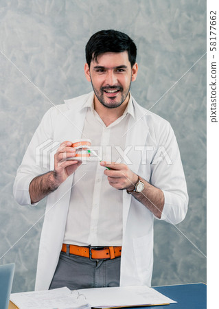 Dentist working with denture in the dental clinic. 58177662